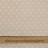 Piqué de coton imprimé cœur fond beige