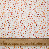 Coton imprimé au gré du vent orange fond blanc
