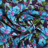 Coton imprimé fleurs exotiques bleu et vert fond violet