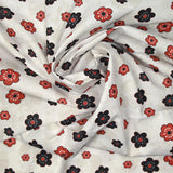 Coton imprimé marguerite noir et rouge fond blanc