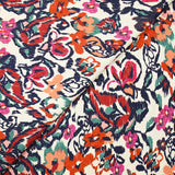 Jacquard de coton natté ikat fleuris orange et bleu fond blanc cassé