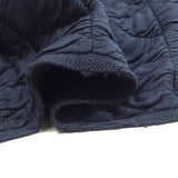Jersey matelassé triangle fond bleu marine