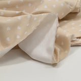 Piqué de coton imprimé cœur fond beige
