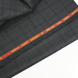 100% Prince of Wales wool tailoring fabric, black, blue, dark gray background