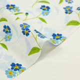 Popeline de coton imprimée fleur bleue et tige verte fond ciel