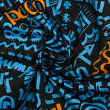 Light cotton satin with blue and orange graffiti print, black background