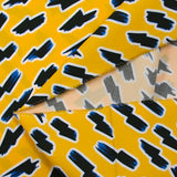 Popelín de algodón ORGÁNICO estampado con fondo amarillo rayo