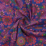 Cotton corduroy printed with psychedelic flowers indigo background