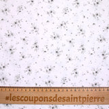 Popeline polycoton imprimée splash de fleurs gris fond blanc