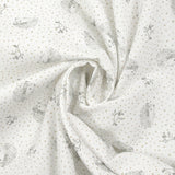 Piqué de algodón con estampado de erizos y lunares color topo sobre fondo blanco.