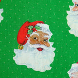Coton imprimé père Noël à pois fond vert