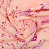 Popeline de coton imprimée papillon fond rose poudre