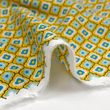 Viscose imprimée fleurs graphiques bleues fond jaune soleil