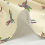 Coton imprimé envolée de colibris fond écru