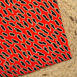 Jersey viscose imprimé petits éclairs noirs fond rouge