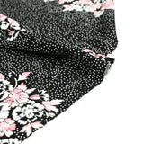 Maille de viscose satinée imprimé pois et fleurs fond noir