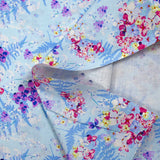 Cotton poplin printed with the shade of ferns on a baby blue background