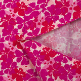 Popeline de coton imprimée fleurs en fusion fuchsia et magenta fond écru