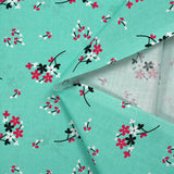 Popeline de coton imprimée souffle fleuri fond aqua