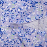 Popeline de coton imprimée nuage de myosotis fond lavande