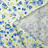 Popeline de coton imprimée fleurs du temps bleu et vert anis fond blanc