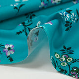Popeline de coton imprimée bouquet champêtre fond turquoise