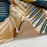 Popeline de coton imprimée grandes feuilles fond beige