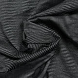 Tela de traje mezcla de lino y lana con puntitos blancos y grises con fondo negro