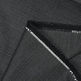 Tela de traje mezcla de lino y lana con puntitos blancos y grises con fondo negro