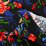 Viscose imprimée bataille de fleurs fond noir