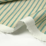 Coton imprimé à rayures hachurées turquoise fond beige clair