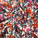Jacquard de coton natté ikat fleuris orange et bleu fond blanc cassé