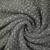 Lainage polyester bouclette et confettis blanc fond gris