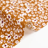 Viscose imprimée fleurs blanches et bordeaux fond ocre