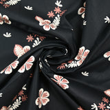 Popeline de coton imprimée fleur aloha marron fond noir