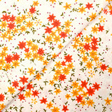 Popeline de coton imprimée fleurs étoilées orange et jaune fond blanc