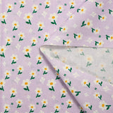 Popeline de coton imprimée marguerite blanche fond mauve