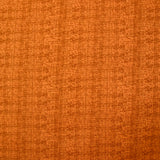 Coton imprimé empreinte fond orange foncé