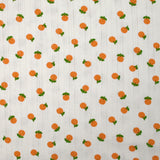 Jersey pointelle coton imprimé orange fond blanc cassé