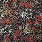 Mousseline imprimée lurex feu d'artifice brique et ocre fond noir