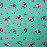 Popeline de coton imprimée souffle fleuri fond aqua