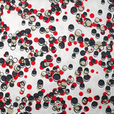 Satin de coton élasthanne dans les bulles rouge fond blanc