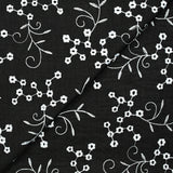 Twill de polyester brodé marguerite fond noir