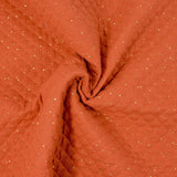 Double gaze matelassé orange confettis doré vendu au mètre
