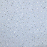 Piqué de coton imprimé pissenlit fond bleu clair
