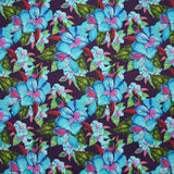 Coton imprimé fleurs exotiques bleu et vert fond violet