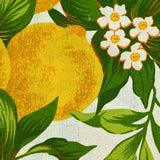 Polycoton imprimé citrons et feuilles vertes fond blanc