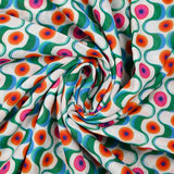 Viscose imprimée agitation verte et orange fond blanc