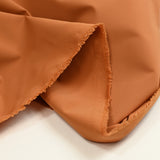 Toile polyester extensible orange brûlé