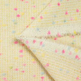 Tweed de laine mélangée confettis rose et bleu fond jaune